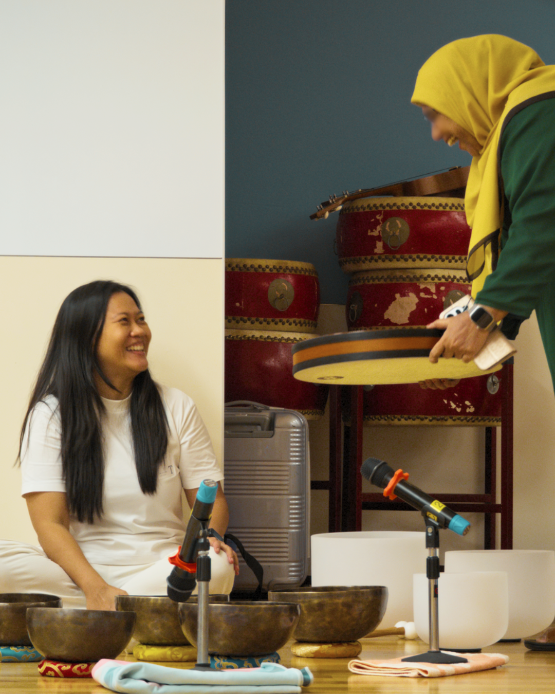 Participant in hijab exploring an ocean drum after a corporate sound bath session.